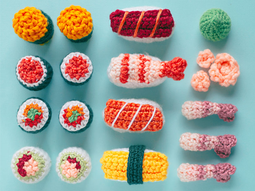 A bunch of different types of crocheted sushi.